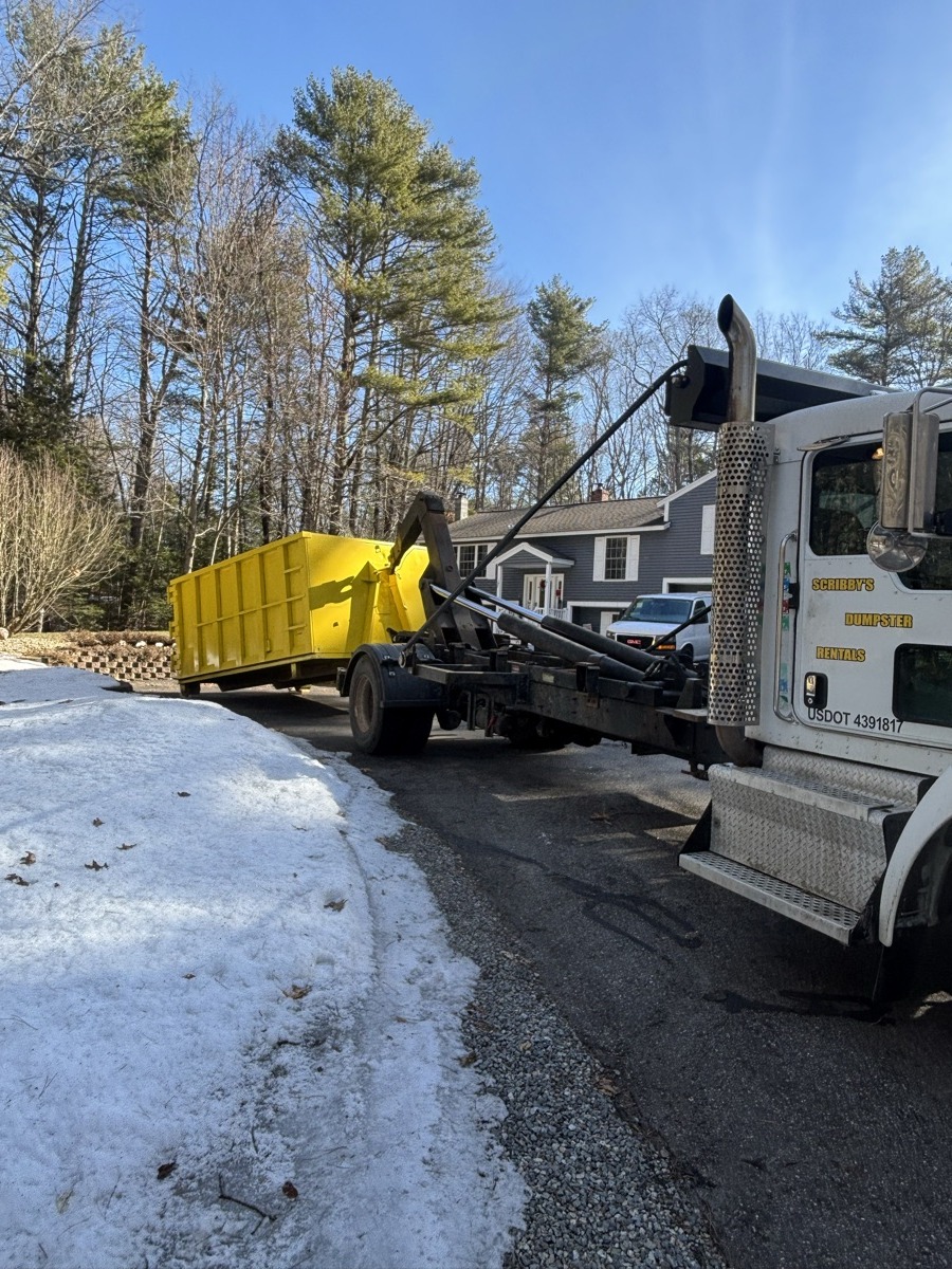 Scribby's dumpster on a Groveland driveway. Maybe an older home near the river, or a residential cleanout on one of the back roads out toward the farmland.