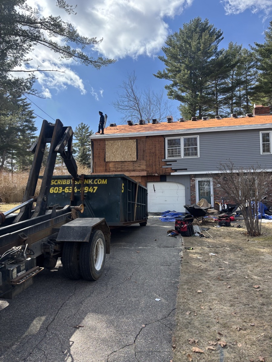 A Scribby's dumpster on a Barnstead driveway. Maybe a residential roof job near Crystal Lake or out on a quiet country road.