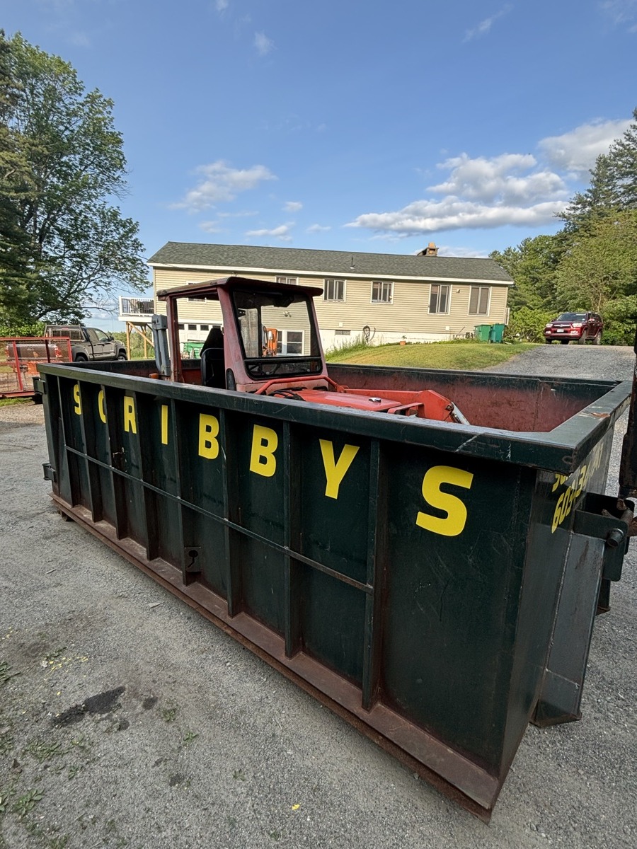 A Scribby's dumpster on a New Castle driveway. Maybe a renovation on a coastal home with the harbor or the Wentworth in the distance.